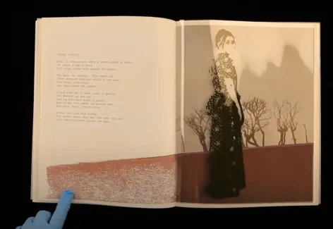 Image of a small open book with text on the left side and a photograph of a woman on the right hand page. She has her body turned to the right but her head is turned to face the viewer. She wears a dress and her hair is up.